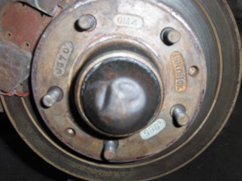1971 Chevrolet Camaro - This close-up shows a wheel hub and brake rotor assembly, various stamped part numbers and markings.
