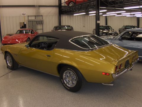 1971 Chevrolet Camaro - This gold coupe features a black vinyl roof and a rear quarter view, with BFGoodrich Radial T/A tires visible.