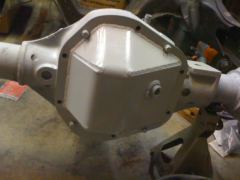 Differential housing painted white, supported by jack stands