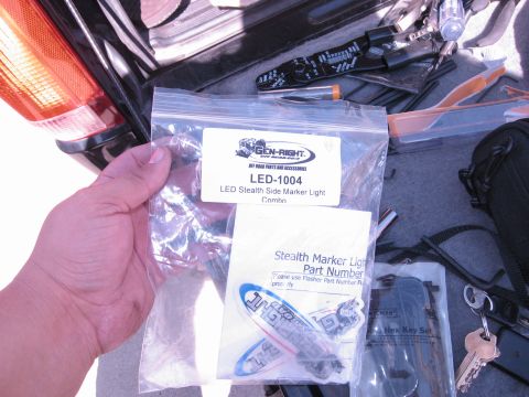 1986 Ford Bronco - A package of LED Stealth Side Marker Lights is shown, with various tools and accessories in the background.