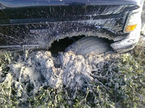 1993 Ford Bronco - This 1993 Ford Bronco is deeply stuck in mud, with the front passenger wheel submerged.