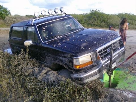 1993 Ford Bronco - This 1993 Ford Bronco is deeply embedded in mud, with a Hi-Lift jack positioned to assist in its extraction.
