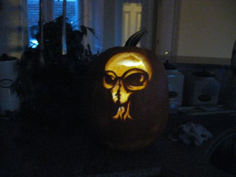 1978 Ford Bronco - A carved pumpkin displays an eerie alien face, illuminated from the inside.