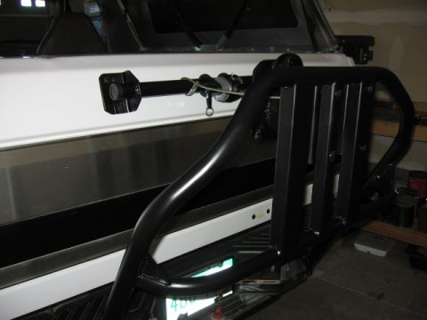 1995 Ford Bronco - Aftermarket rear bumper and tire carrier mount on a white vehicle.