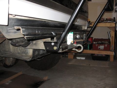 1995 Ford Bronco - Close-up of a vehicle's rear bumper and tow hitch assembly, with a toolbox visible in the background.