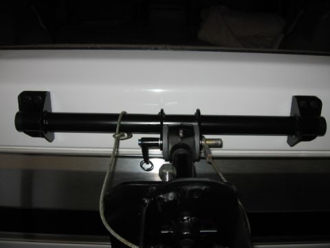 1995 Ford Bronco - Close-up of a frame mount drop down tire carrier system attached to the rear of a white vehicle.