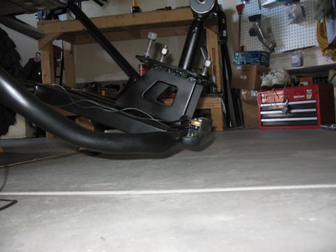1995 Ford Bronco - Aftermarket tire carrier mount assembly in a garage setting.
