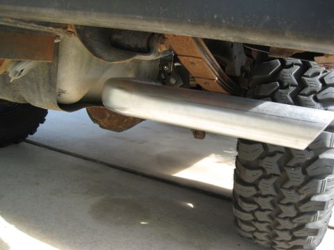 1995 Ford Bronco - Undercarriage view shows a shiny exhaust pipe and a tire.