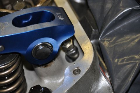 1996 Ford Bronco - Close-up of a blue roller rocker arm with a 1.6F ratio marking, part of an engine's valve train.