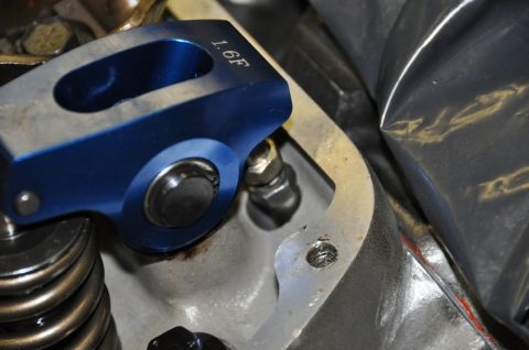 1996 Ford Bronco - A close-up view of an engine's valve train, focusing on a blue roller rocker arm with a ratio marking.