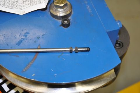 1996 Ford Bronco - Close-up of a metal tube and fitting on a blue tube bending machine.
