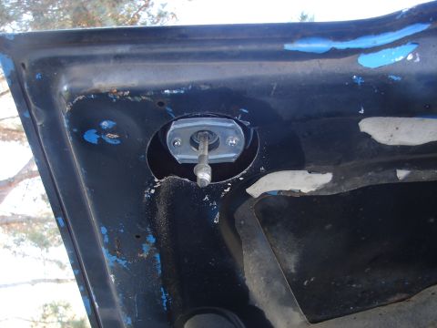 1973 Ford Ranchero - The underside of a car hood shows a mounting bracket and bolt assembly.