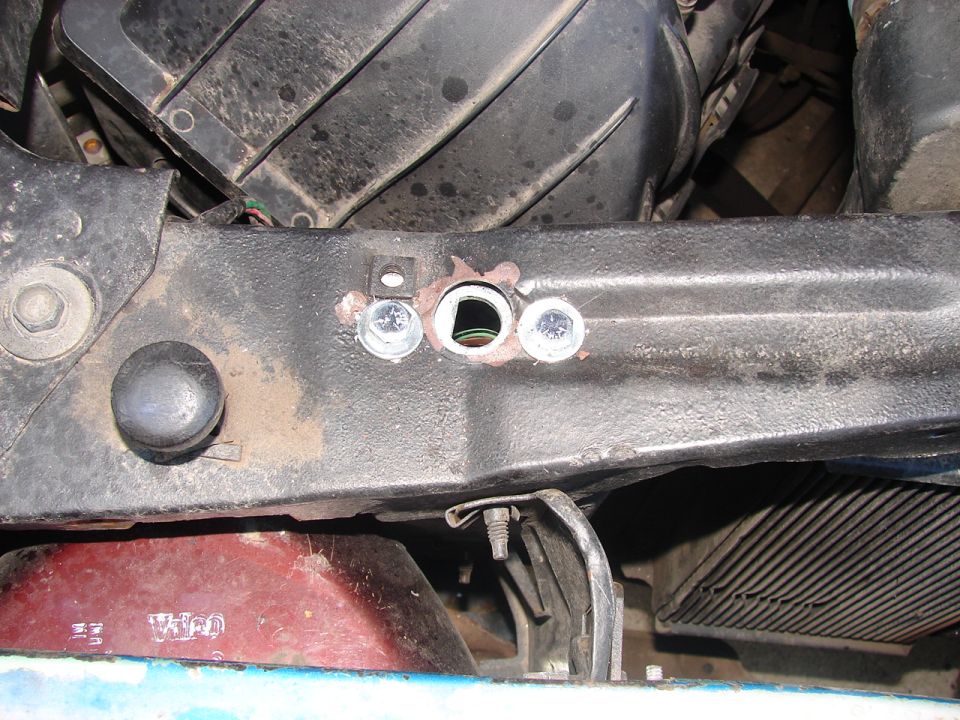 Close-up of engine bay with bolts and wiring