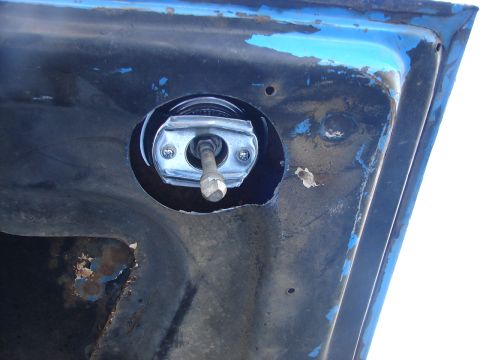 1973 Ford Ranchero - Underside of a vehicle hood showing the latch mechanism and surrounding metalwork.