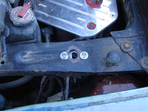 1973 Ford Ranchero - The engine bay shows a coolant reservoir and a chrome valve cover, with visible bolts and wiring.