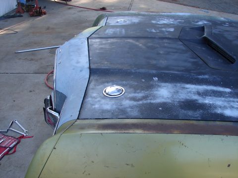 1973 Ford Ranchero - A car's hood and fender, partially prepped for paint, display signs of wear and tear.