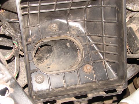 1973 Ford Ranchero - A close-up view of a black plastic air cleaner housing with a Ford logo.