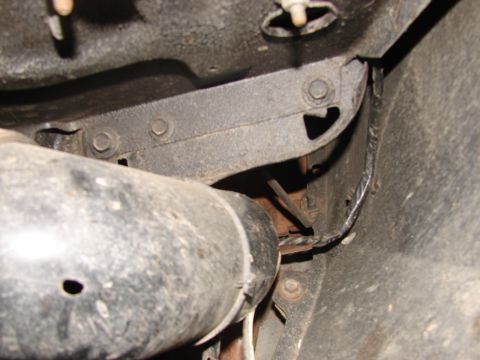 1973 Ford Ranchero - Undercarriage view of exhaust pipe and frame components, likely from an older vehicle.