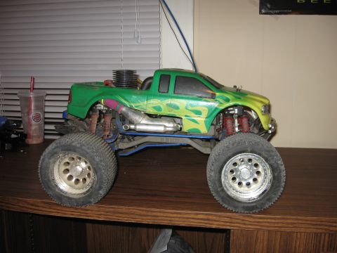 1992 Ford Ranger - This remote control monster truck features a green body with flame graphics and oversized wheels.