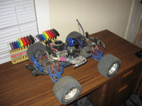 1992 Ford Ranger - A blue remote control monster truck sits on a wooden desk next to a rack of colorful tools.
