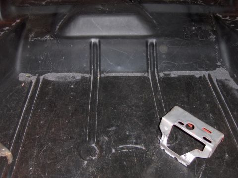 1970 Chevrolet Camaro - Trunk floor pan showing a metal bracket. No year is discernible.