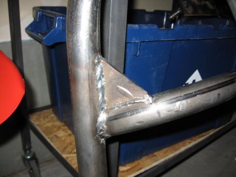 1995 Ford Bronco - Welded metal tubing with a triangular brace is shown in detail, with a blue container in the background.