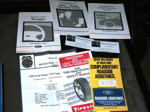 1986 Ford Bronco - Various documents including owner's guides for a 1999 Ford Ranger and roadside assistance information are displayed.