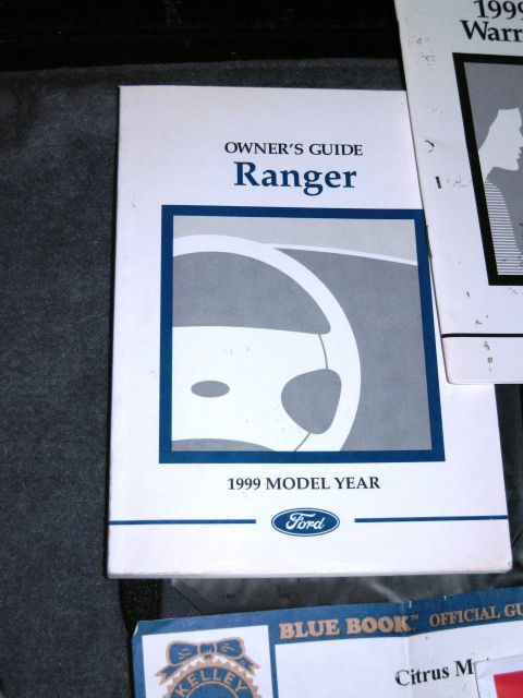 1986 Ford Bronco - Owner's guide for a 1999 Ford Ranger is shown next to other automotive documents.