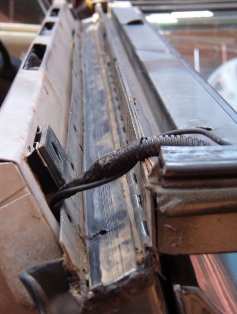1975 Ford Bronco - There's a lot of dirt on the lower hinge plate, but the real problem is between that plate & the top of the firewall.