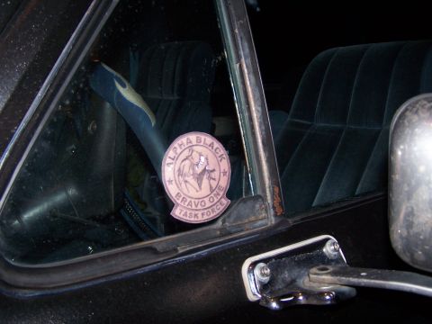 1986 Ford Bronco - Close-up of a sticker on a vehicle's window, with interior seats visible in the background.