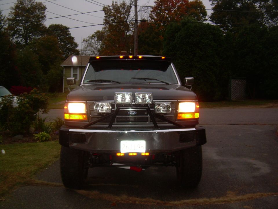 Front view of a 1995 Ford F-150 with aftermarket lights and bumper