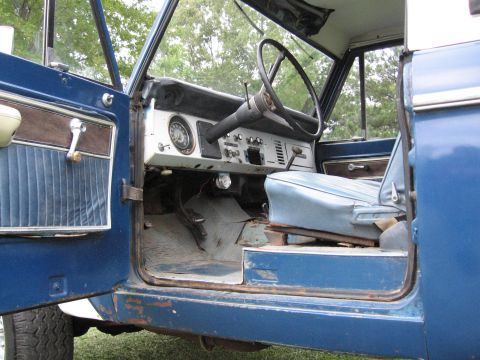 1967 Ford Mustang - Interior view of a blue vehicle, showing the dashboard, steering wheel, and driver's seat. No year is visible.