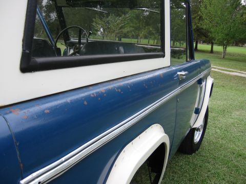 1967 Ford Mustang - The side profile of a vintage SUV shows its two-tone paint scheme and weathered exterior.
