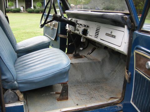 1967 Ford Mustang - The interior of a blue vehicle features light blue vinyl seats and a white dashboard with "EXPLORER" badging, suggesting it might be a Ford…