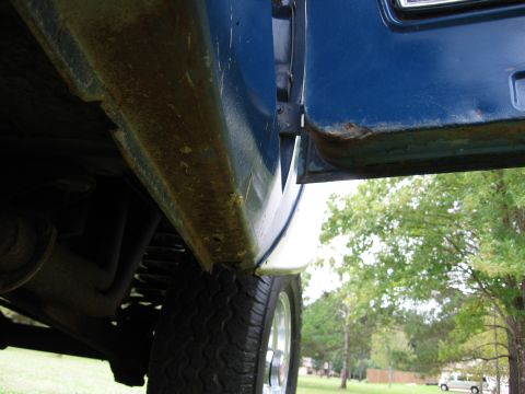 1967 Ford Mustang - Close-up view of rust on a vehicle's rocker panel and door bottom.