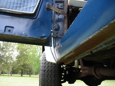 1967 Ford Mustang - Close-up view of a vehicle's open door and fender, revealing rust and interior details.
