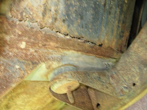 1967 Ford Mustang - Close-up of heavily rusted vehicle undercarriage components, showing significant corrosion.