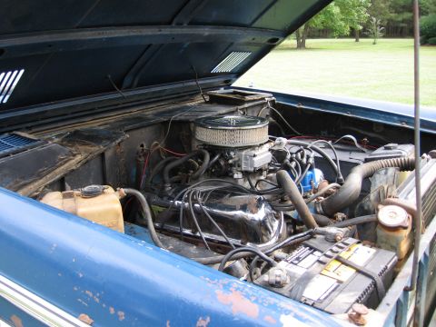 1967 Ford Mustang - Close-up of the engine bay of a blue vehicle, showing the V8 engine components.