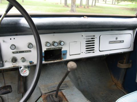 1967 Ford Mustang - Dashboard interior an 'EXPLORER' badge and a manual transmission shifter.