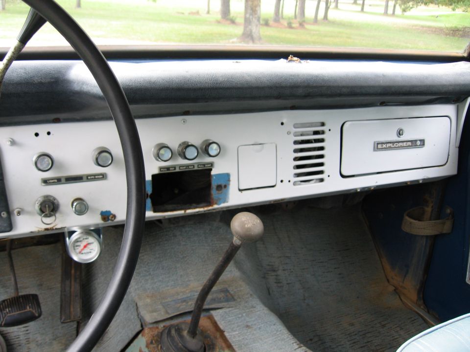 Interior dashboard with 'EXPLORER' badge and manual shifter