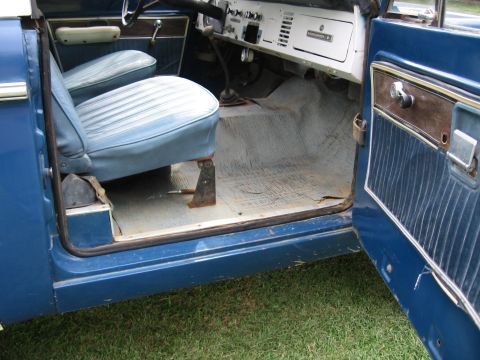1967 Ford Mustang - The interior of a blue 1974 Ford Bronco shows its vinyl seats and manual transmission shifter.