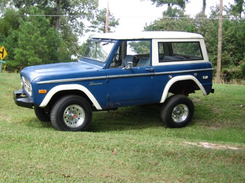 1967 Ford Mustang - This 1974 Ford Bronco is seen from the side, a blue body with a white hardtop.