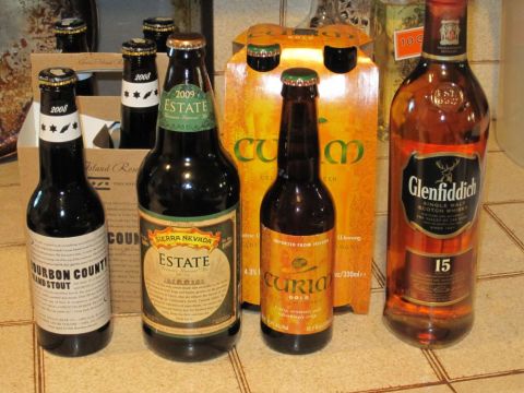 1990 Ford Bronco - A collection of alcoholic beverages including craft beers and a bottle of Glenfiddich 15 Scotch whiskey.