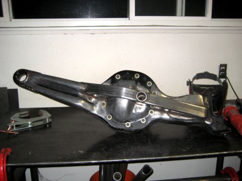 1996 Ford Bronco - A modified rear axle differential housing sits on a workbench, ready for installation.