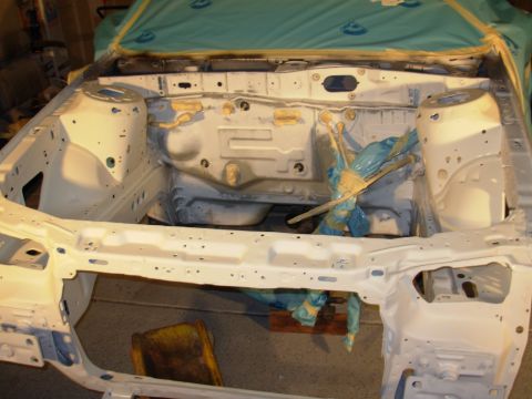 1995 Ford Taurus - Stripped engine bay frame of a car, ready for restoration work.