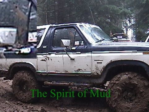 1982 Ford Bronco - Ford Bronco navigating deep mud, with text overlay 'The Spirit of Mud' and 'Supermotors.net'.