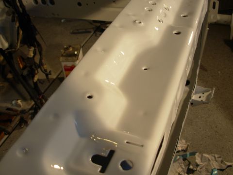 1995 Ford Taurus - White painted car frame section, likely undergoing restoration or repair.