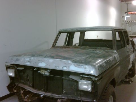 1979 Ford F-250 - This four-door Ford pickup truck is in the process of being prepped for paint, with its front end partially disassembled.