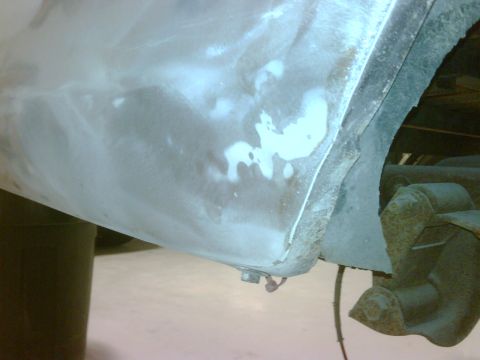 1979 Ford F-250 - Bodywork in progress on a vehicle's rear section, with primer and filler applied to the panel.