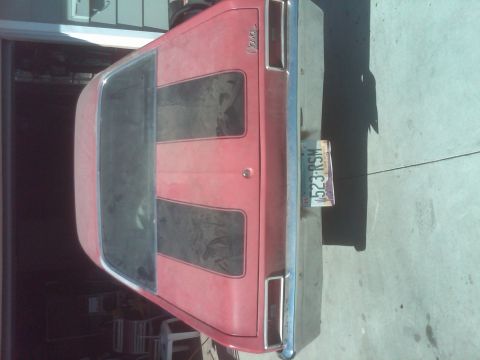 1982 Ford Bronco - Rear view of a red 1970 Chevrolet Nova with black racing stripes and a license plate.